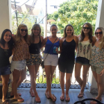 Bachelorette party taking a picture on the balcony.