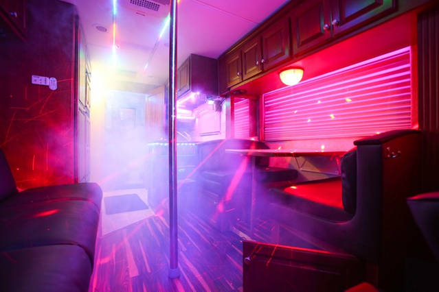 Inside the Party Bus fog and dancer pole.